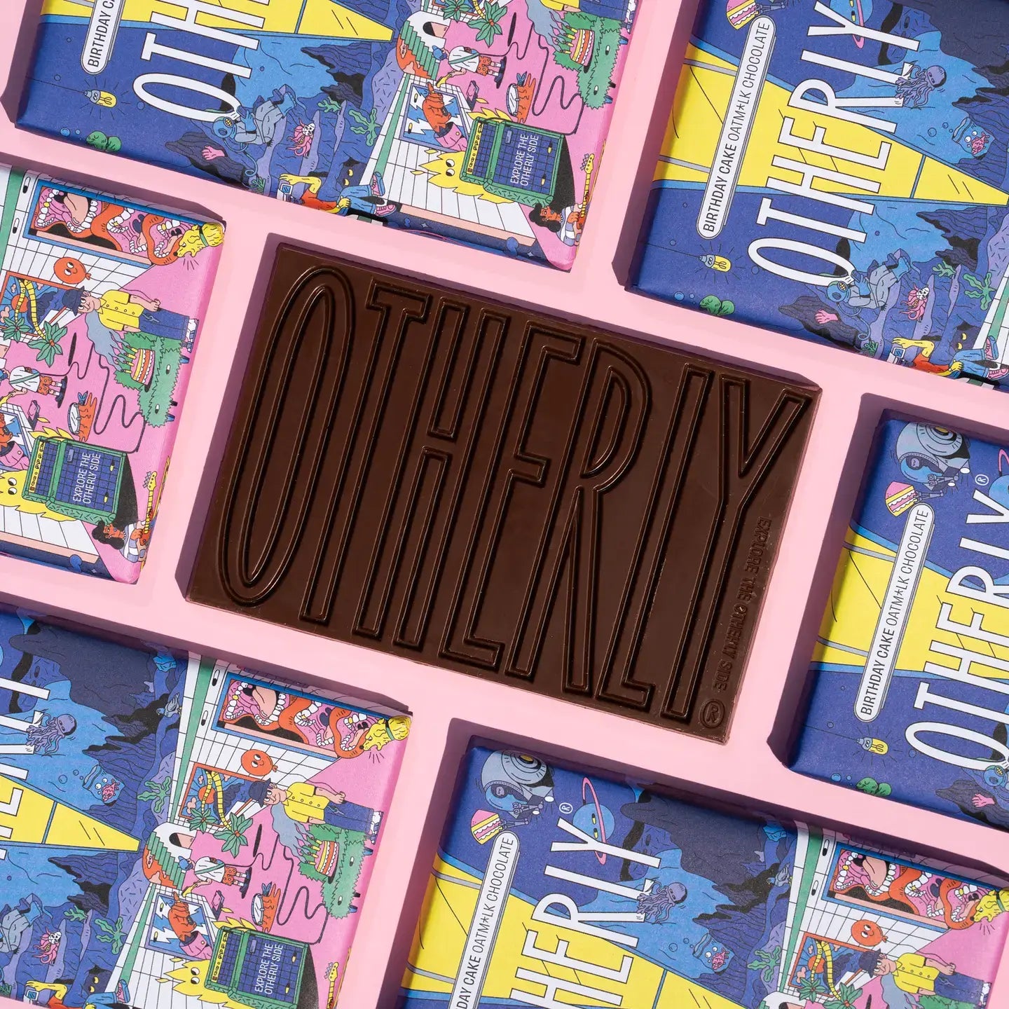 Chocolate bar with 'OTHERLY' branding surrounded by colourful packaging