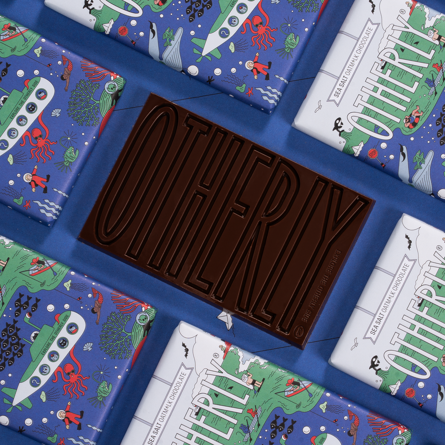 Chocolate bar with 'Otherly' branding surrounded by colourful packaging