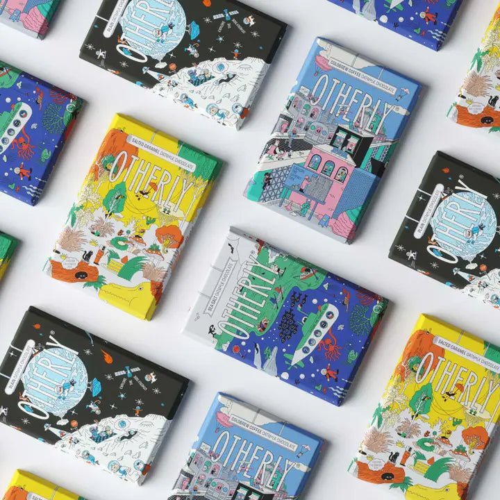 Colourful chocolate titled 'Otherly' on a white surface
