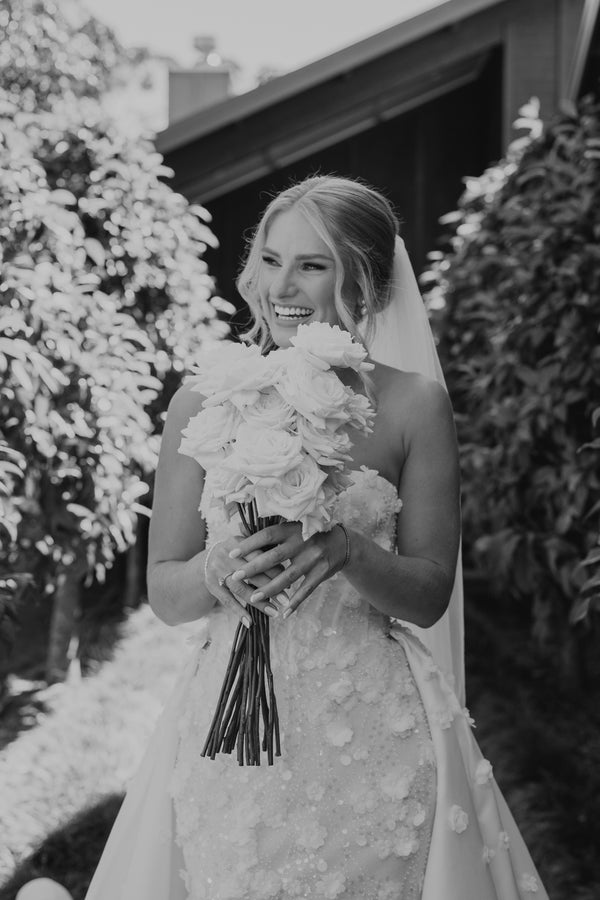 Bride holding a bouquet of flowers outdoors