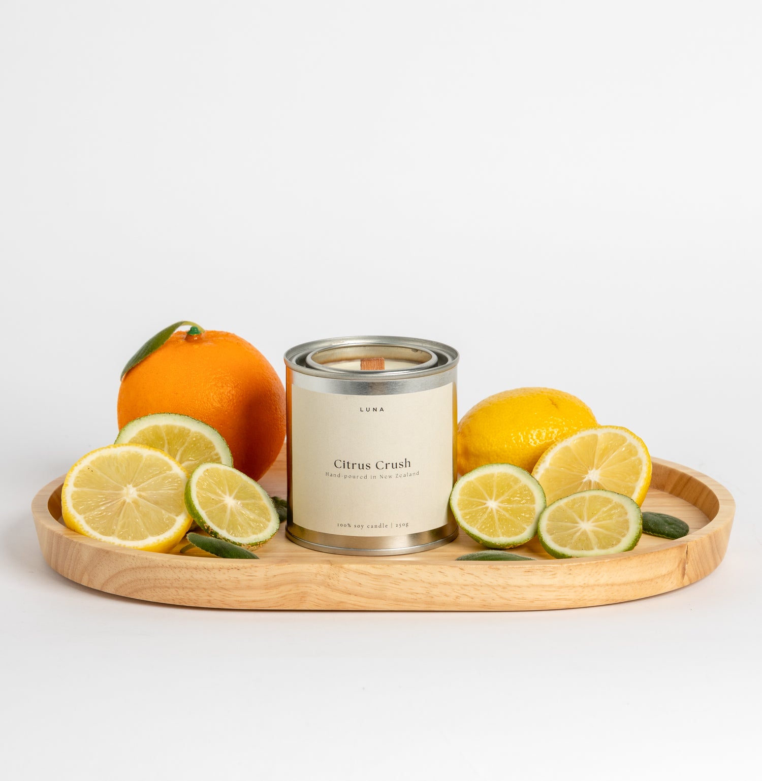 Citrus Crush candle close-up with fresh citrus and basil inspired packaging
