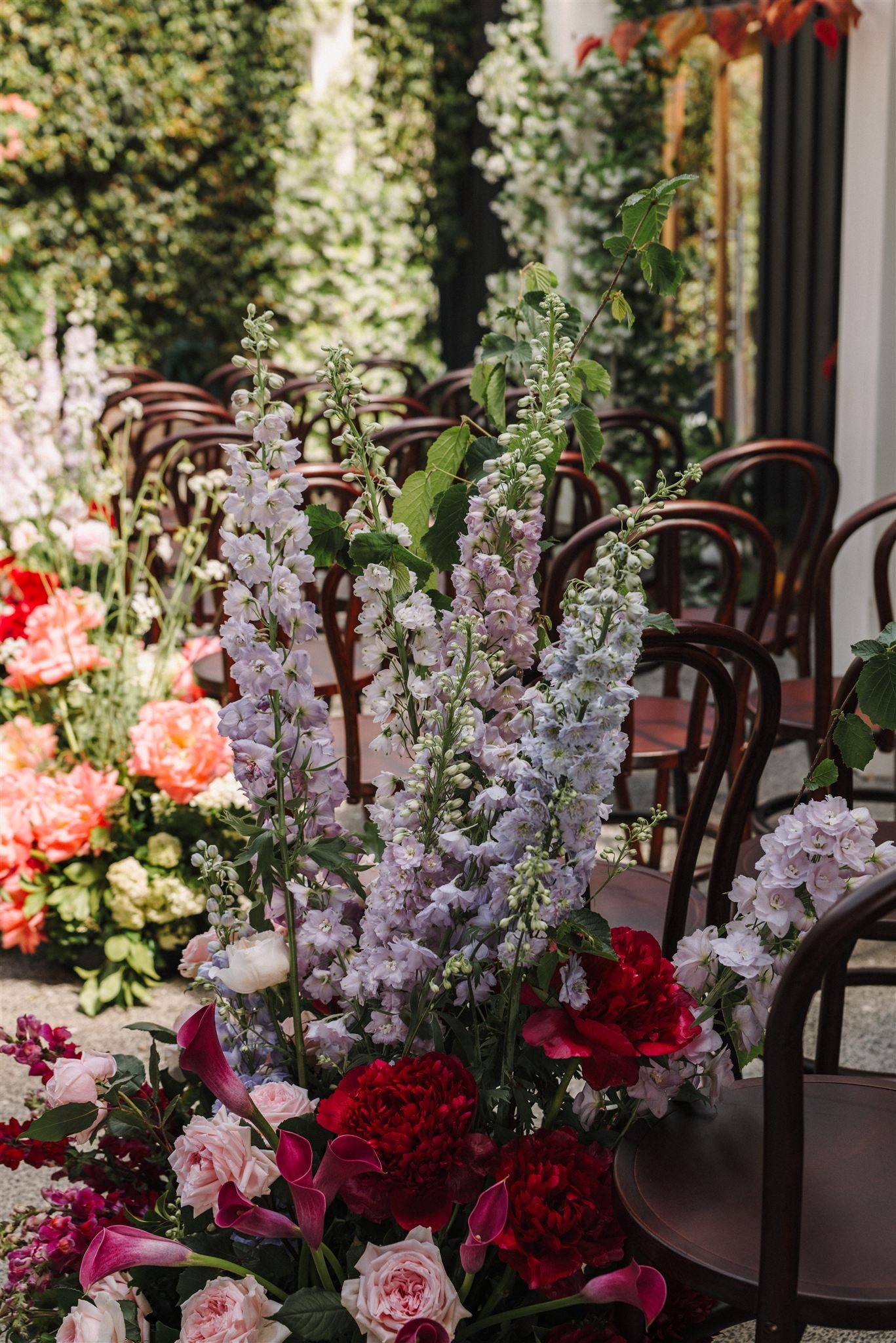 Decorative floral floor arrangement with colourful flowers in a garden setting.
