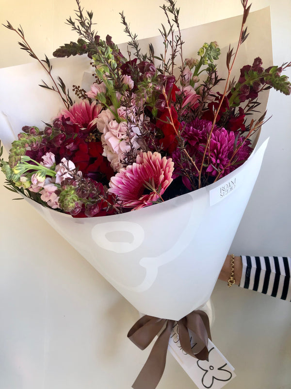 Red shop bouquet of flowers in a white wrap