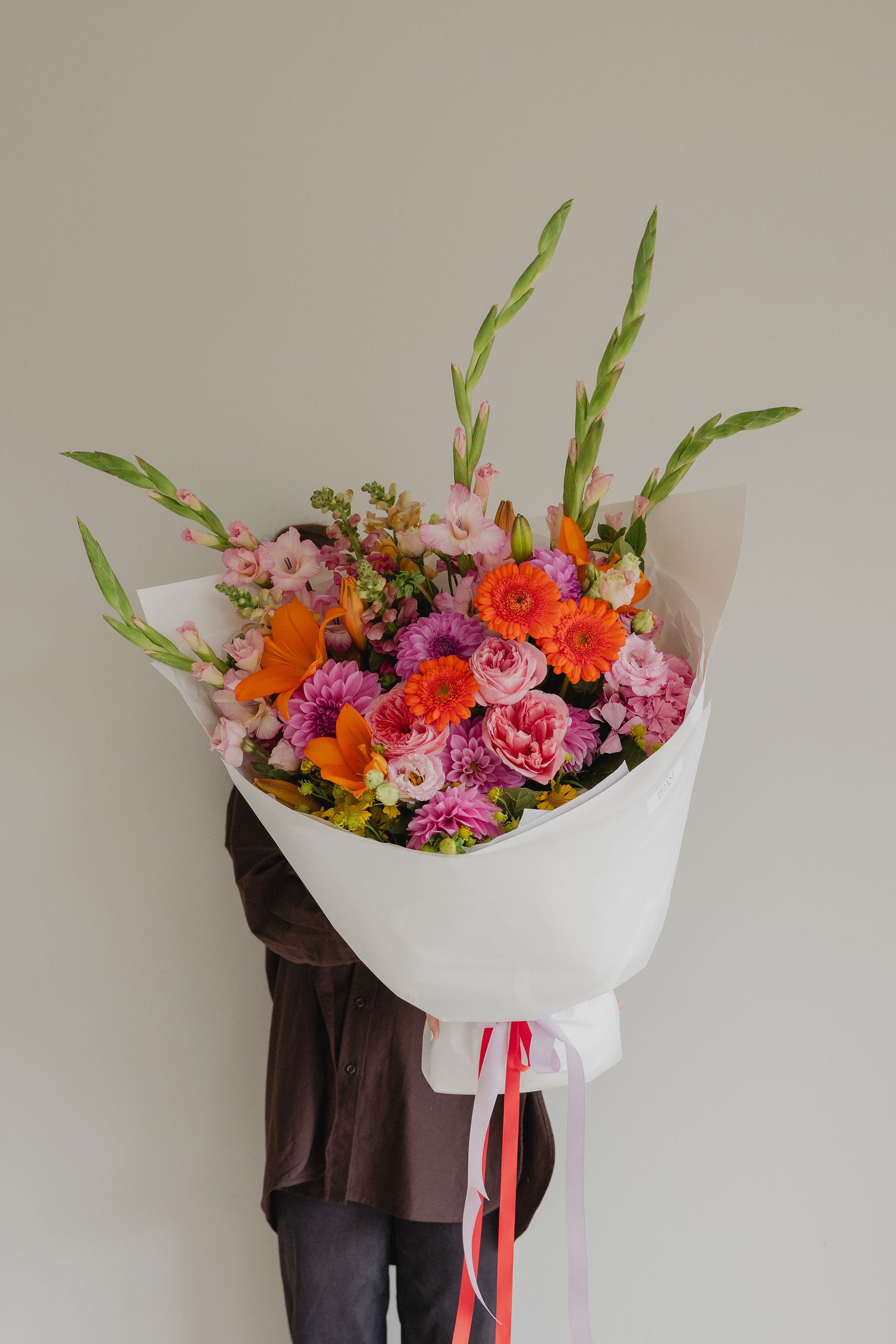 Firecracker bright seasonal bouquet gift wrapped for delivery