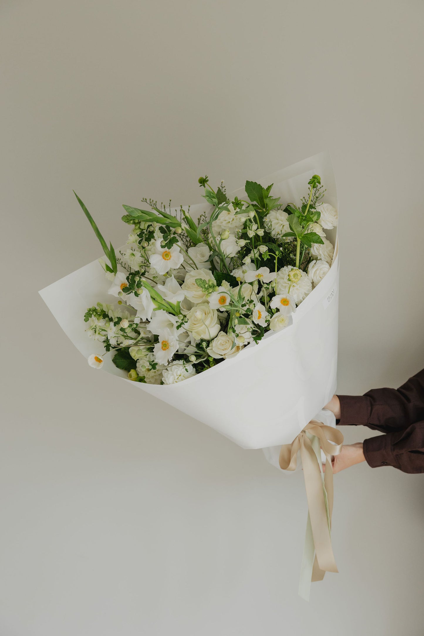 Simple Pleasures bouquet close-up with soft white flowers and layered greenery
