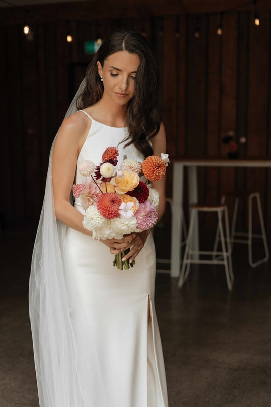 Bride holding a bouquet of flowers in an indoor setting