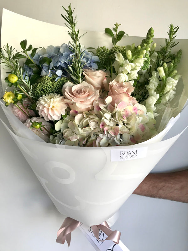 soft pastel bouquet in white wrap with hydrangea